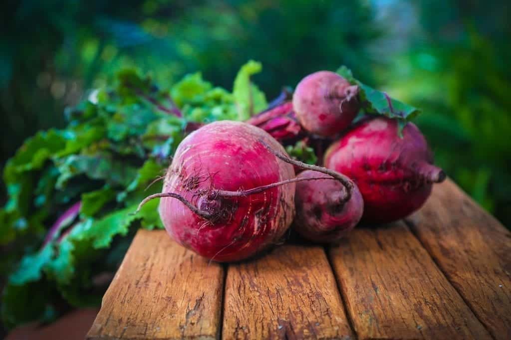 Frozen beets on a wooden table.