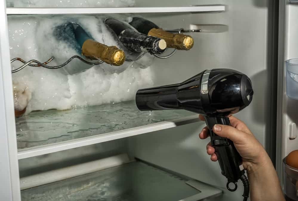 Hairdryer Defrosting Ice in a Freezer